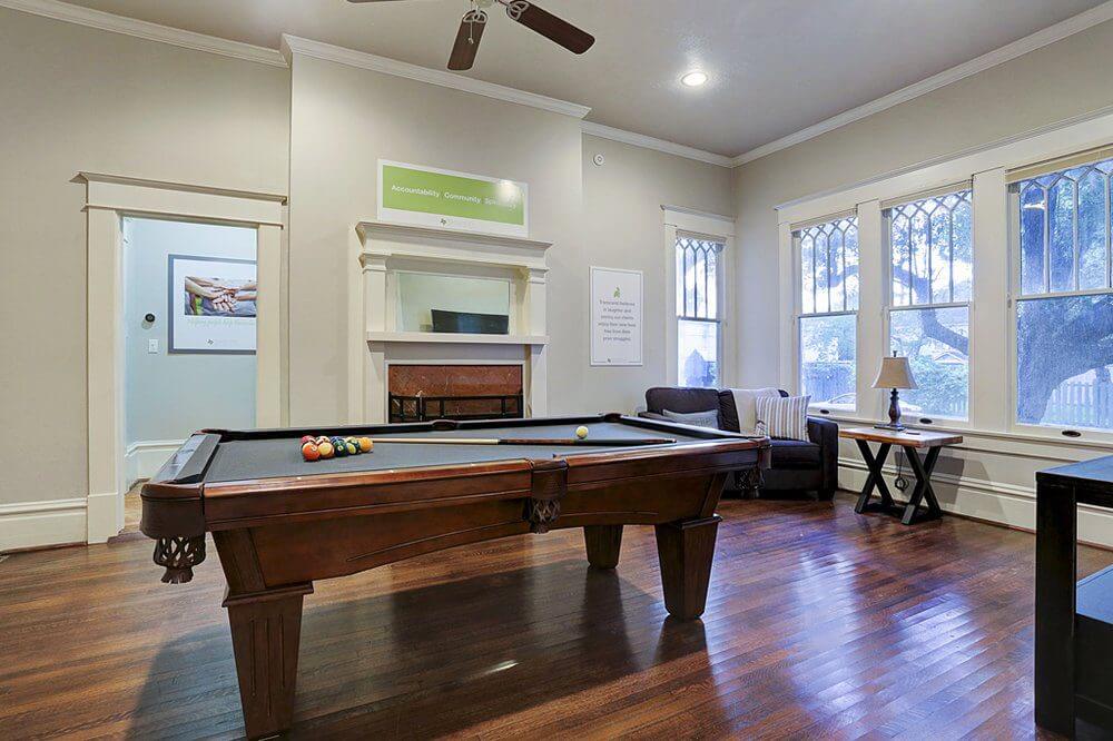 Game room at Harvard House men’s recovery home in Houston Heights